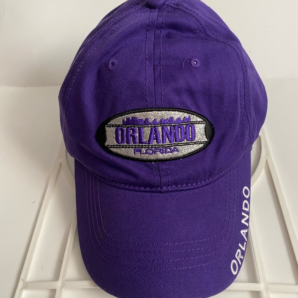 Preowned ORLANDO FLORIDA Hat. Purple with bling on front. Adjustable